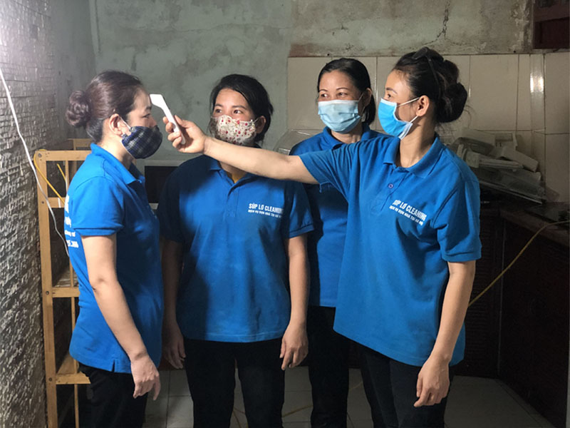 Nhân viên Súp Lơ đo thân nhiệt trước khi vệ sinh nhà tại Dịch Vọng